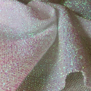 May include: White iridescent mesh fabric with a subtle sparkle. The fabric has a woven texture and is slightly translucent.
