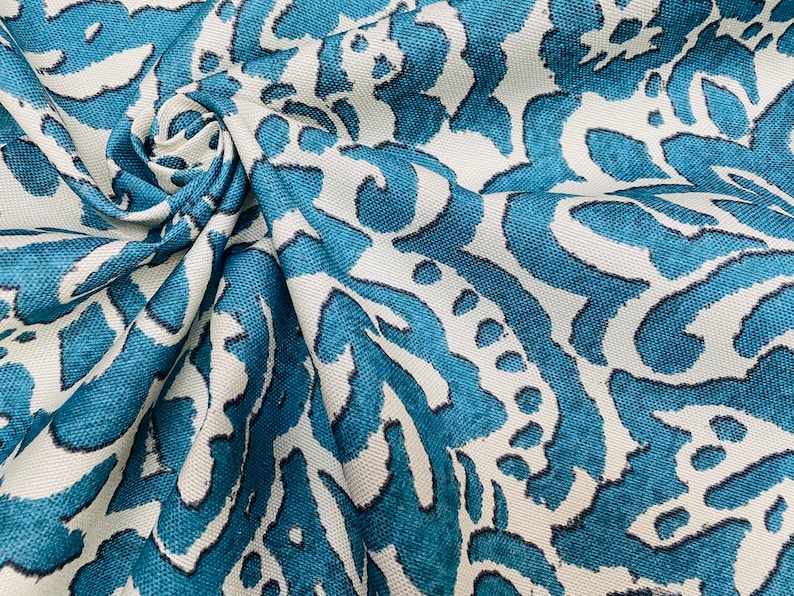 May include: Teal and white fabric with a large-scale, abstract floral pattern. The fabric has a textured, woven look.