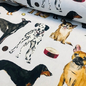May include: A white fabric featuring a repeating watercolor illustration of various dog breeds including a black and tan dachshund, a spotted dalmatian, a tan chihuahua, and a fawn french bulldog, interspersed with small dog bones and bowls.