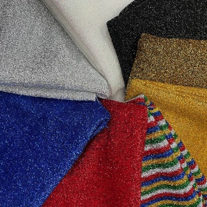 May include: A collection of six different sparkly fabrics in various colors, including silver, black, gold, blue, red, and a multi-colored striped fabric.