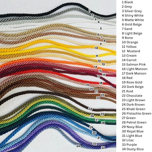 May include: A collection of thirty-four twisted cords arranged in wavy horizontal lines, each labeled with a corresponding number and color name ranging from black, white, and beige to yellow, red, brown, green, blue, and purple hues.