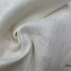 May include: Cream colored linen fabric with a woven texture.