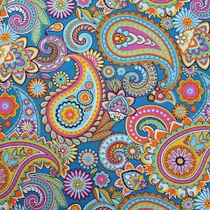 May include: A colorful paisley pattern fabric with a blue background. The fabric features a variety of paisley shapes in shades of orange, yellow, pink, and green.