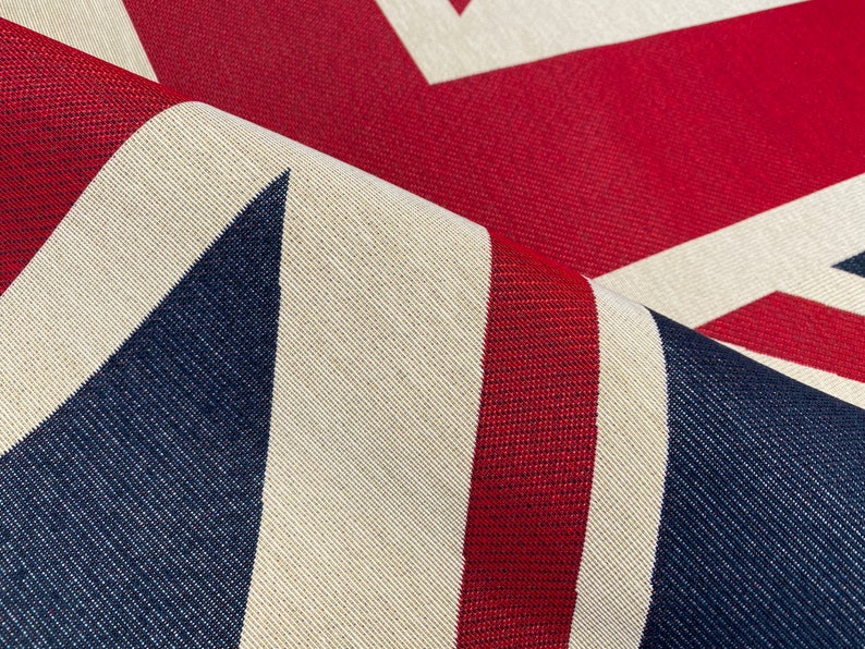 May include: Close-up of a fabric with a Union Jack pattern. The fabric is red, white, and blue and has a textured weave.