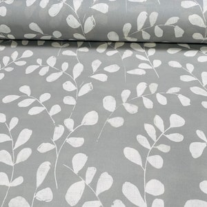 May include: Grey fabric with a white leaf pattern. The leaves are stylised and have a slightly distressed look.