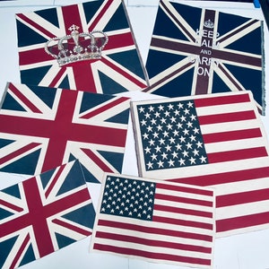 May include: Five fabric flags with different designs. The flags are all rectangular and have a white background with red, blue, and white stripes. The flags are all in different sizes and are arranged in a random order. The flags are all made of fabric and have a soft, textured feel. The flags are all in good condition and have no rips or tears.