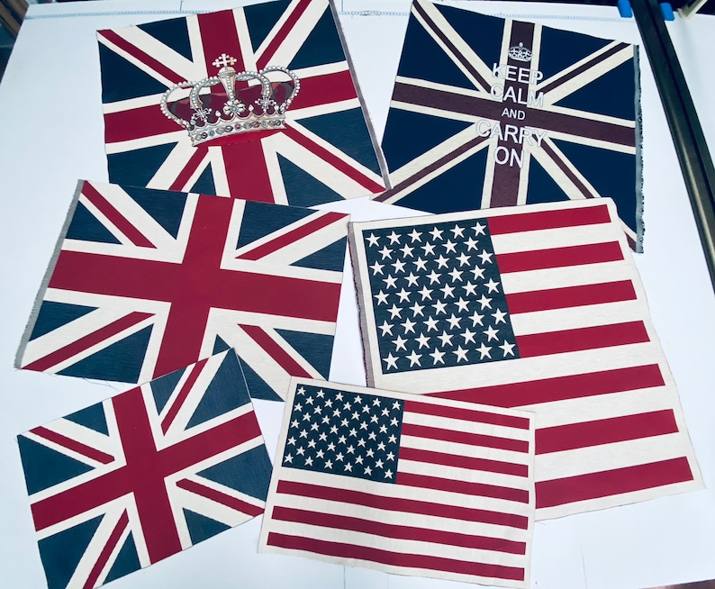 May include: Five fabric flags with different designs. The flags are all rectangular and have a white background with red, blue, and white stripes. The flags are all in different sizes and are arranged in a random order. The flags are all made of fabric and have a soft, textured feel. The flags are all in good condition and have no rips or tears.