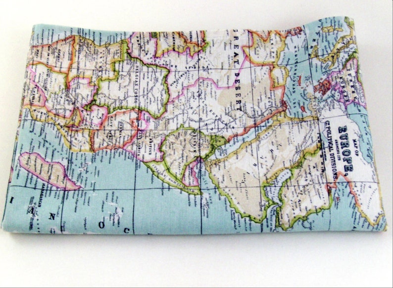 May include: A vintage map of Europe printed on fabric. The map is in shades of blue, green, yellow, pink, and brown. The map shows the political divisions of Europe. The text on the map reads "Map of Europe, Showing its Geo-Political Divisions, Drawn 1878."