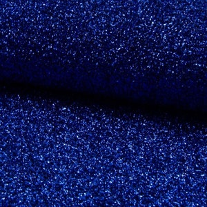 May include: A close-up of a blue fabric with a sparkly, glittery texture.