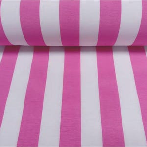 May include: A roll of fabric featuring a bold pattern of alternating vertical stripes in bright pink and white. The fabric is tightly rolled, showcasing the repeating stripe design. The stripes are of equal width, creating a visually striking and clean aesthetic.