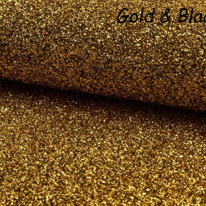 May include: Gold glitter fabric with a black back. The fabric has a textured, sparkly appearance.