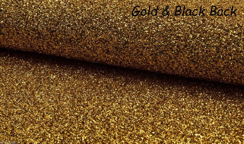 May include: Gold glitter fabric with a black back. The fabric has a textured, sparkly appearance.