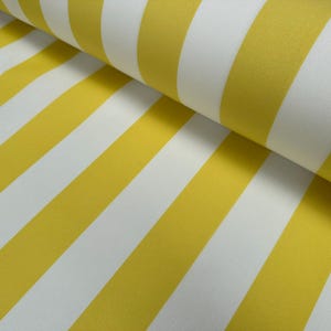 May include: Yellow and white striped fabric. The fabric is folded in half, showing the stripes running diagonally.