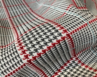 Puede incluir: Primer plano de una tela de pata de gallo roja, negra y blanca con textura tejida.