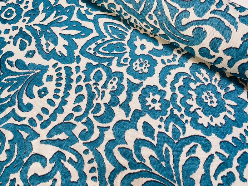 May include: Teal blue and white fabric with a damask pattern. The fabric has a textured, slightly raised design.