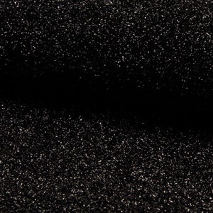 May include: Black fabric with a sparkly, glittery texture. The fabric is folded in half, creating a crease down the center.