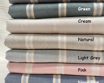 May include: A stack of folded fabric in various colors, including charcoal, green, cream, natural, light grey, pink, navy blue, and beige. Each fabric has vertical stripes in cream and light blue. The labels on the fabric read "Charcoal", "Green", "Cream", "Natural", "Light Grey", "Pink", "Navy Blue", and "Beige".