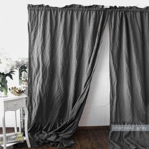 May include: A pair of charcoal gray curtains featuring a ruffled top header and a ruffled bottom hem. The fabric has a visible textured weave and hangs in soft, vertical folds. The text "charcoal gray" is printed in the bottom right corner.