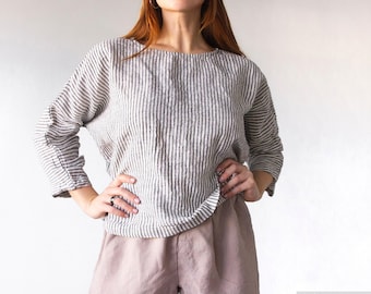 Camicia oversize in lino bianco: maniche a 3/4, vestibilità comoda.