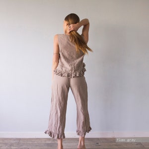 May include: A light brown linen pants and top set with ruffles. The pants are cropped and the top is sleeveless. The set is called "flax gray".