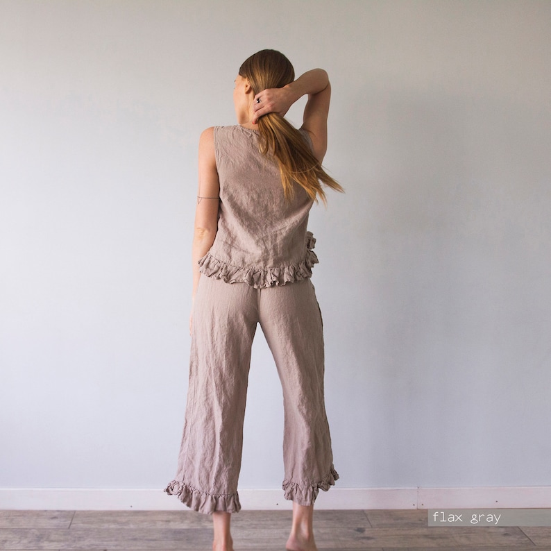May include: A light brown linen pants and top set with ruffles. The pants are cropped and the top is sleeveless. The set is called "flax gray".