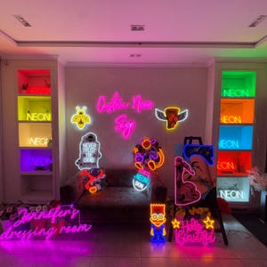 May include: A collection of neon signs with various designs and colours, including a bee, a skull, a pizza slice, a cartoon character, and the text "Custom Neon Sign".