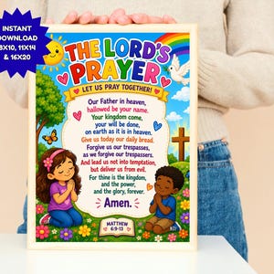 May include: A colorful wall art print featuring The Lord's Prayer with text, a rainbow, a sun, a dove, a cross, and two children praying in a grassy field. The print includes the text "The Lord's Prayer," "Let us pray together!," and "Matthew 6:9-13."