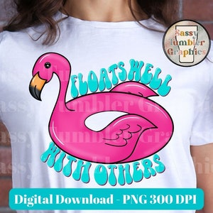May include: White t-shirt featuring a pink flamingo pool float with the text "FLOATS WELL WITH OTHERS" in turquoise. The design includes the text "Digital Download - PNG 300 DPI". A logo for "Sassy Tumbler Graphics" is in the upper right corner.