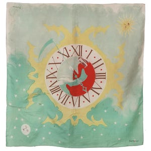 May include: A square silk scarf with a celestial design. The scarf features a clock face with Roman numerals, a red crescent moon, and a yellow sun. The background is light blue with white stars and clouds. The word "Jacqmar" is printed in the corners.