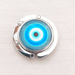 Crochet de sac à main Evil Eye en bleu vif, accroche-sac à main pliable pour dessus de table, énergie positive pour conjurer les ondes négatives, accessoires de sac