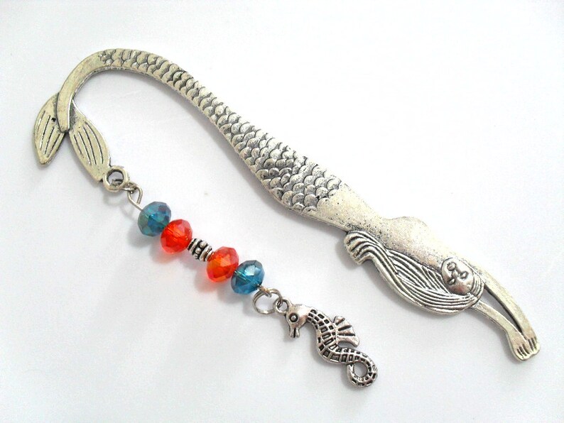 Mermaid tail metal bookmark with silver tone seahorse charm.  Orange and teal crystal beads were used in this handmade mythical beach book accessory. The book hook is durable and will fit any size book, planner or journal.  A 5 inch full size hook.