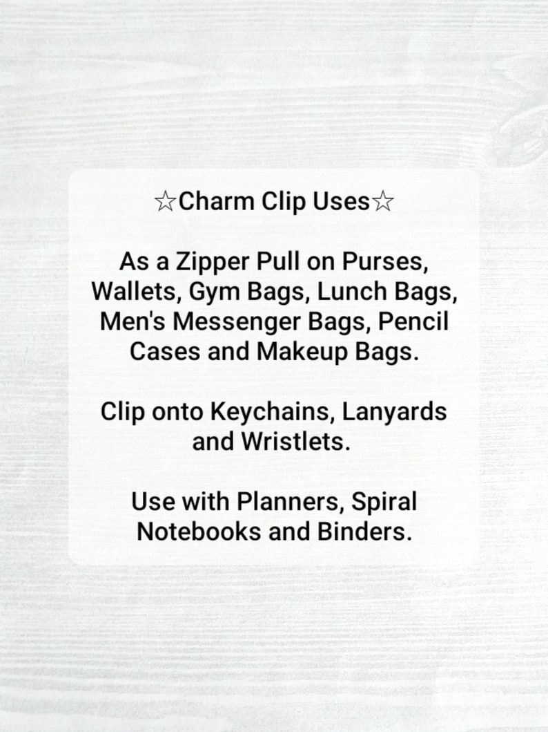 May include: White card with the text "Charm Clip Uses" and a list of applications: zipper pulls, keychains, lanyards, planners, notebooks, and binders. The card is on a light wood grain background.