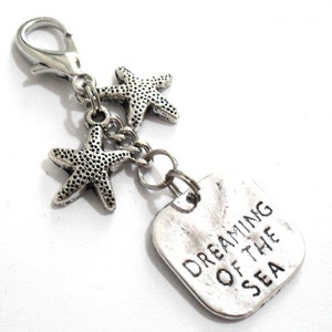 A 2 1/2 inch beach planner charm, starfish keyring clasp or sea pendant zipper pull.  The DREAMING OF THE SEA pendant has an attractive watery/wave appearance.  The 18mm lobster clasp is large enough to fit the majority of zippers and keychains.