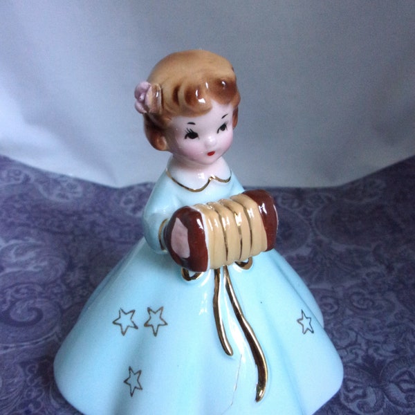 Vintage Josef Originals Porcelain Girl with Accordion. A fine line at front of the figurine. Still a beautiful collectible piece.