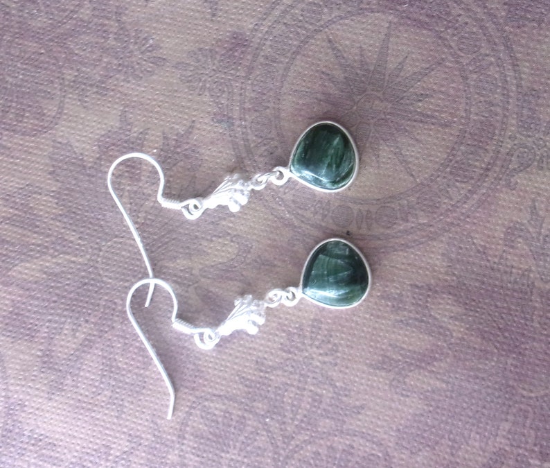 Exquisite handcrafted Seraphinite and sterling silver drops. Beautiful artist design, 1.95in Long. The Gem is approx. .50in diameter.
