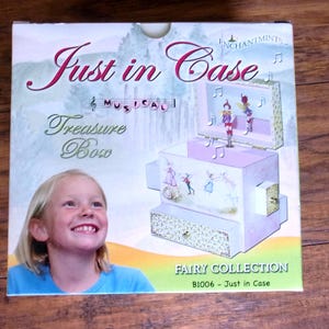 Adorable "Just In Case" Fairy Musical Treasure Box with four secret drawers in which girls can storage their tiny treasures.
The little fairy figurine moves with the melody that rings out.  
Measures: 6" x 6" x 4" W.  New in the original box.
 Was opened only to take the photos.