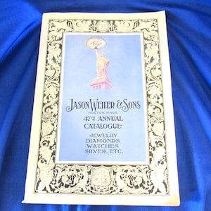 May include: A vintage catalog cover featuring the Statue of Liberty, with the text "JASON WEILER & SONS" and "47th ANNUAL CATALOGUE". The catalog lists jewelry, diamonds, watches, and silver.