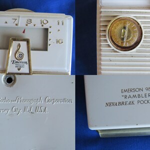 May include: A vintage Emerson 988 "Rambler" pocket radio in off-white. It has a tuning dial, speaker grill, and a gold-toned emblem with the Emerson logo. The back of the radio is labelled with the manufacturer's name and location.