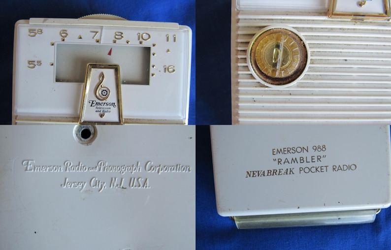 May include: A vintage Emerson 988 "Rambler" pocket radio in off-white. It has a tuning dial, speaker grill, and a gold-toned emblem with the Emerson logo. The back of the radio is labelled with the manufacturer's name and location.