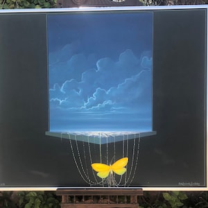 May include: A framed painting of a yellow butterfly with a blue sky and clouds in the background. The butterfly is hanging from a string of beads. The painting is signed "Robert C. Goodley".