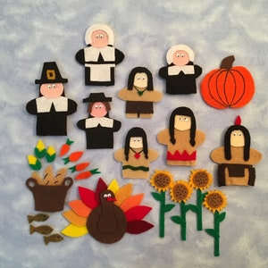 May include: Felt finger puppets depicting a Thanksgiving feast, including Pilgrims, Native Americans, a turkey, a pumpkin, corn, carrots, sunflowers, and fish.