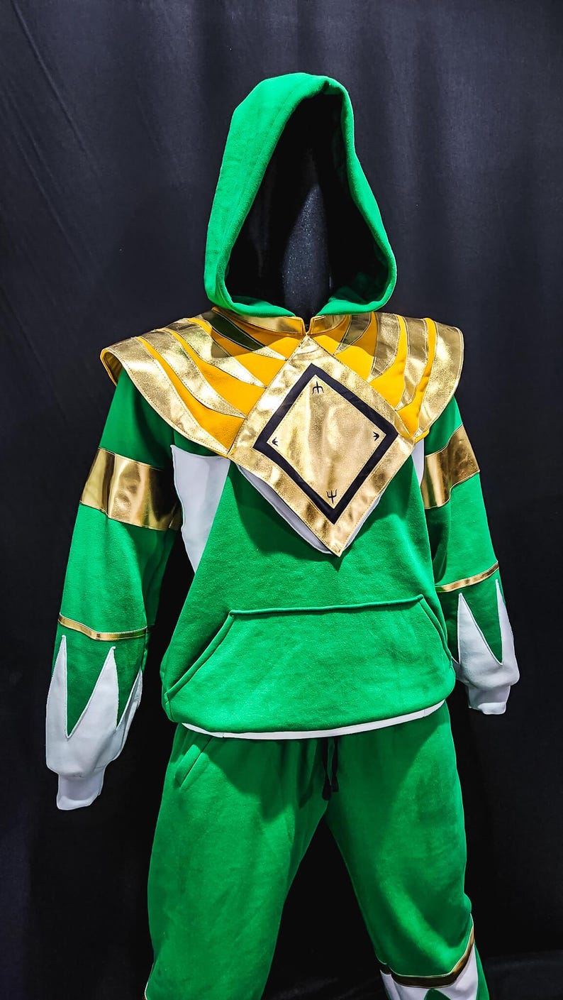 The MMPR Green Hoodie features a bold green fleece body combined with premium vegan leather accents, offering a battle-ready look inspired by the iconic Mighty Morphin Power Rangers. Designed for collectors and cosplayers, this hoodie merges classic hero aesthetics with modern comfort.