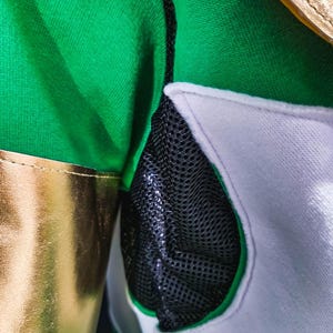 With tailored structure and premium materials, the MMPR Green Hoodie captures the legacy of the Green Ranger. The design balances function and form, featuring light-up upgrade options for enhanced design elements, creating a futuristic yet classic look.