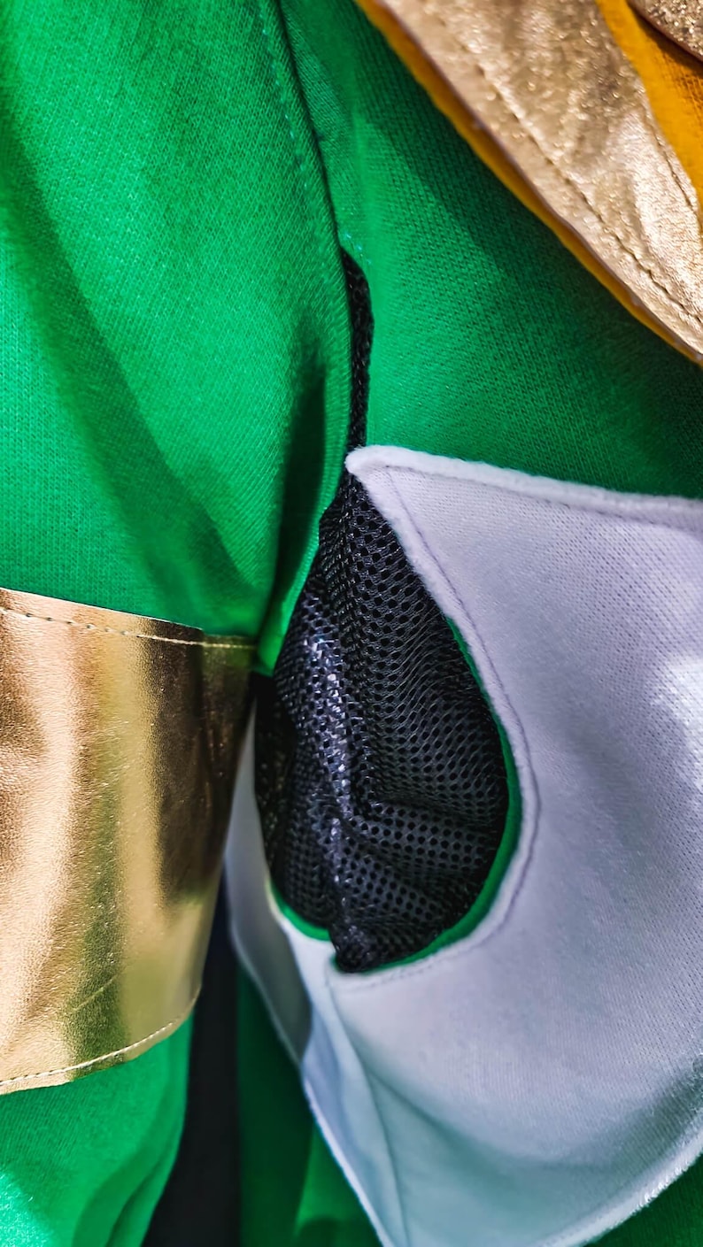 With tailored structure and premium materials, the MMPR Green Hoodie captures the legacy of the Green Ranger. The design balances function and form, featuring light-up upgrade options for enhanced design elements, creating a futuristic yet classic look.