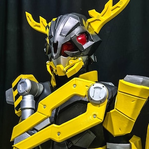 May include: A yellow and black robot figure with a horned helmet and red eyes. The robot has a large, yellow, segmented arm with a silver detail.