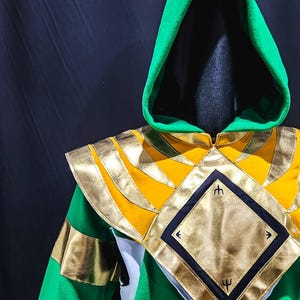 Inspired by the timeless hero, the MMPR Green Hoodie blends everyday wearability with collector-grade detail. Its rich green fleece base, paired with vegan leather armor elements, creates a sophisticated and heroic silhouette for fans of iconic Ranger designs.