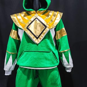 This MMPR Green Hoodie is a tribute to legendary Power Rangers legacy, combining comfortable fleece fabric with high-quality vegan leather detailing and an optional lighting effect upgrade, transforming it into a powerful fashion statement.