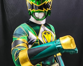May include: Green and gold superhero costume with a matching helmet. The helmet has a visor and a crest with a red gem. The costume features a geometric pattern and gold accents on the gloves and belt.