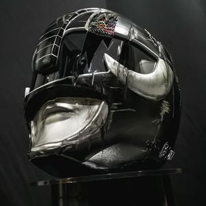 Battle-worn Black Ranger MMPR Helmet Damaged Custom, handcrafted from resin/fiber with optional lighting. A collector-grade piece made to order—perfect for cosplay or display.