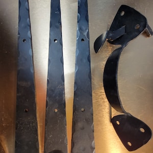 May include: Three black metal hinges with decorative scalloped edges and a black metal latch with a curved handle.